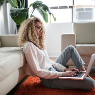 Woman working on a laptop in a living room