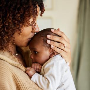 Mother kissing baby