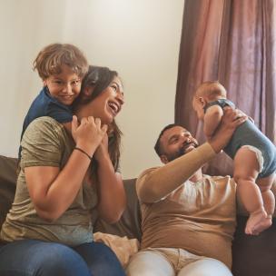 Family playing on a couch